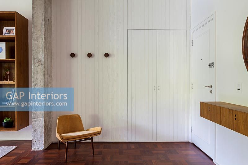 Brown and white hallway with wooden painted doors 
