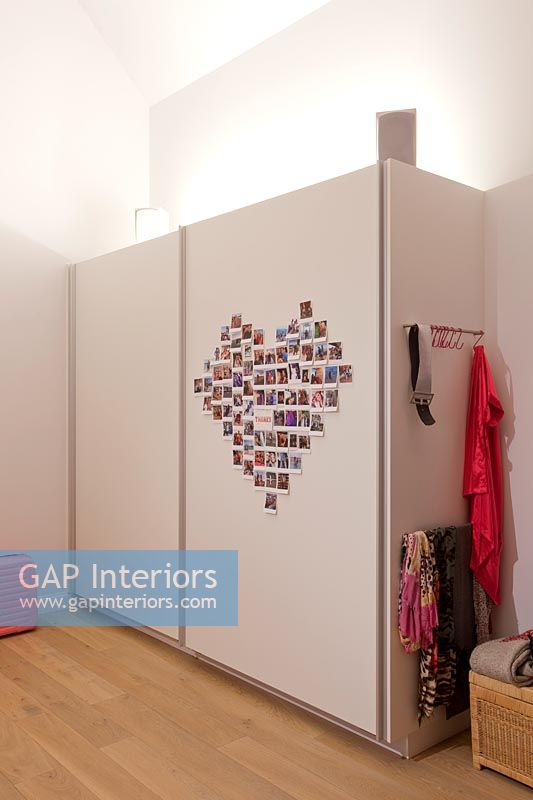 Heart shaped display of photos on wardrobe 