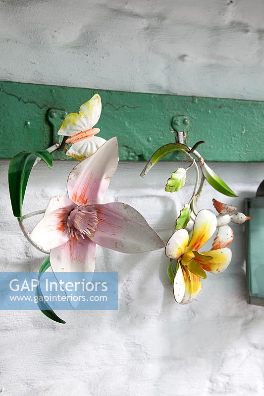 Decorative metal flowers on old coat hooks 