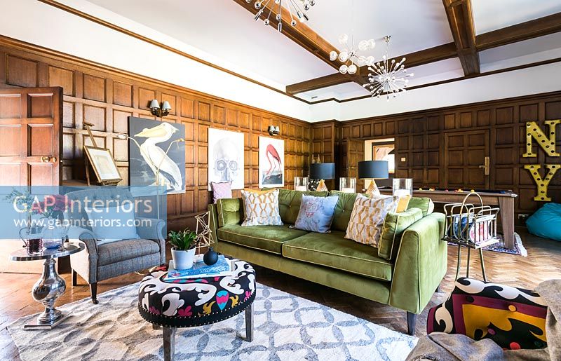 Eclectic living room with classic wooden paneling and exposed beams