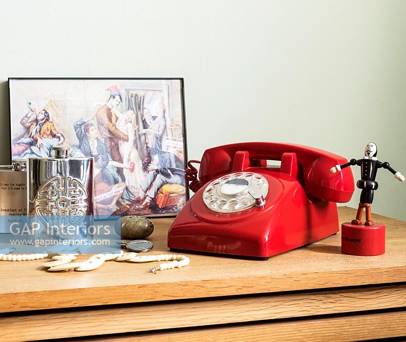 Red retro telephone on table 