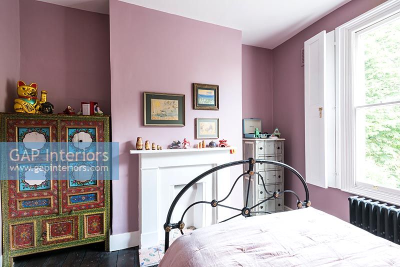 Pink bedroom with painted oriental style wardrobe 