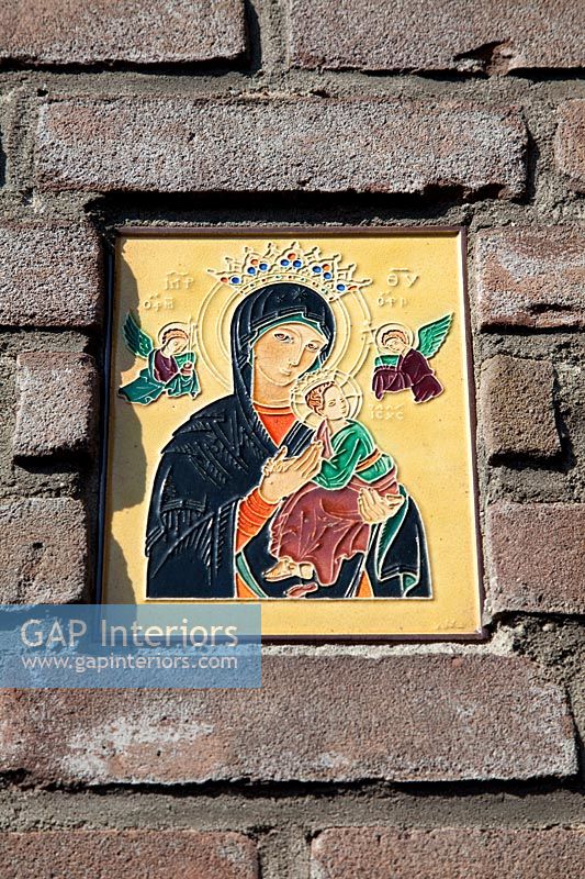 Close up religious tile in wall
