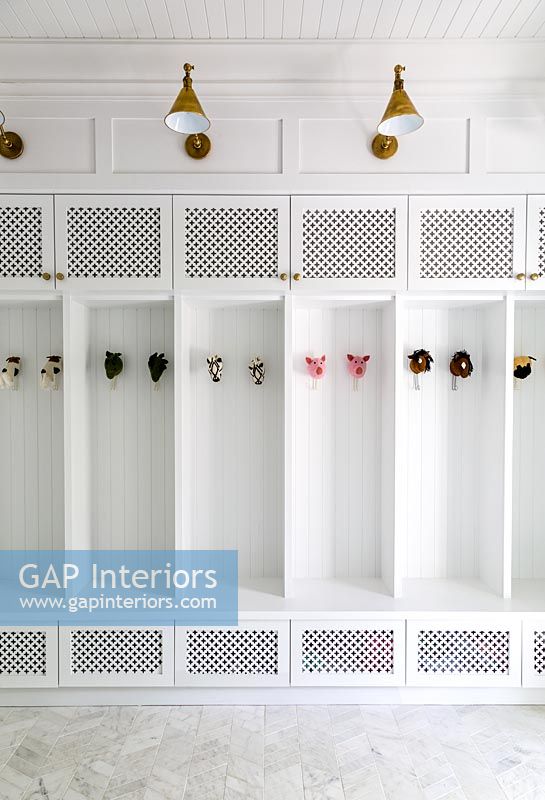 White built-in cabinet with toys for coat hooks