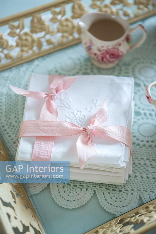 White serviettes tied with pink ribbon 