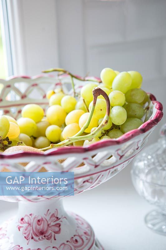 Pink and white latticed fruit bowl with grapes 