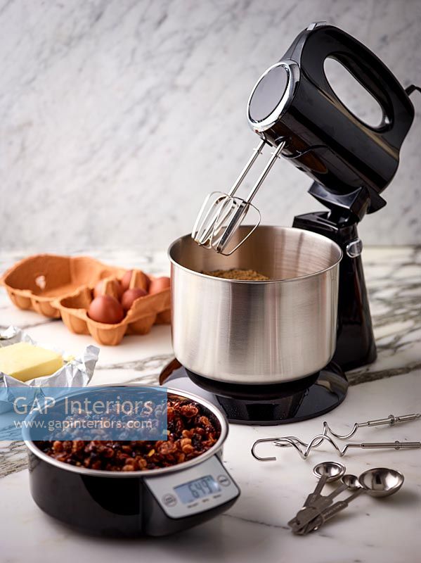 Food on scales and electric mixer in kitchen 