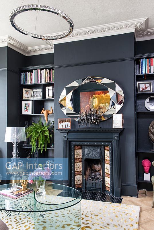 Black painted feature wall and fireplace in modern living room 