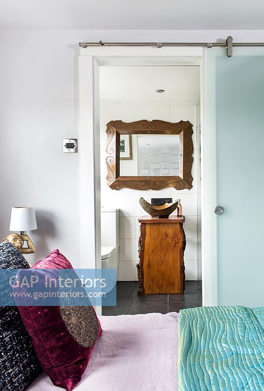 View through open bedroom door to en-suite bathroom 