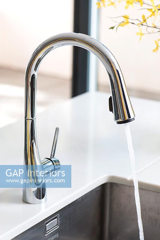 Modern kitchen faucet with running water