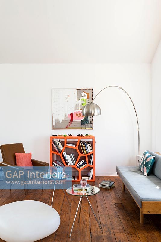 Modern living room with unusual orange bookshelf unit 