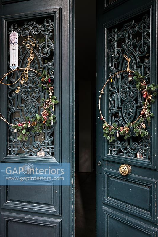 Wreaths on decorative double front doors 