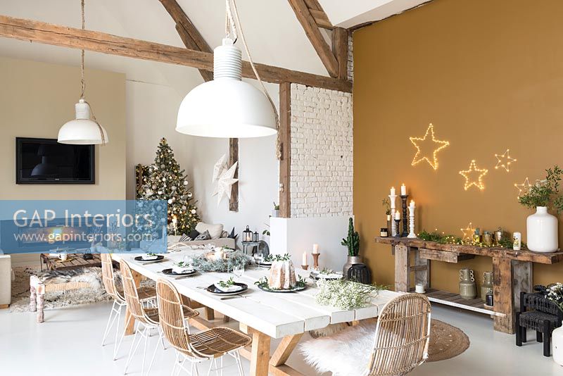 Open plan living space with dining table set for Christmas