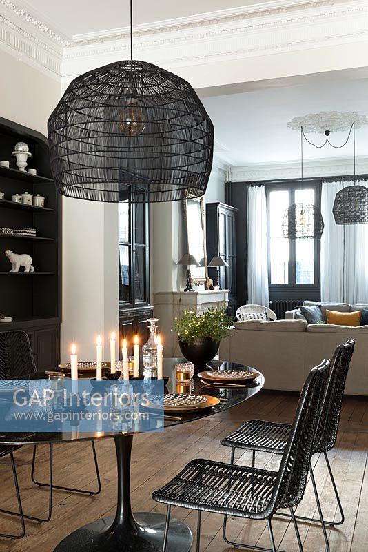 Modern dining room with lit candles on table 