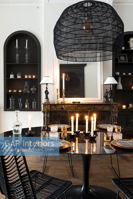 Modern black and white dining room with candles 