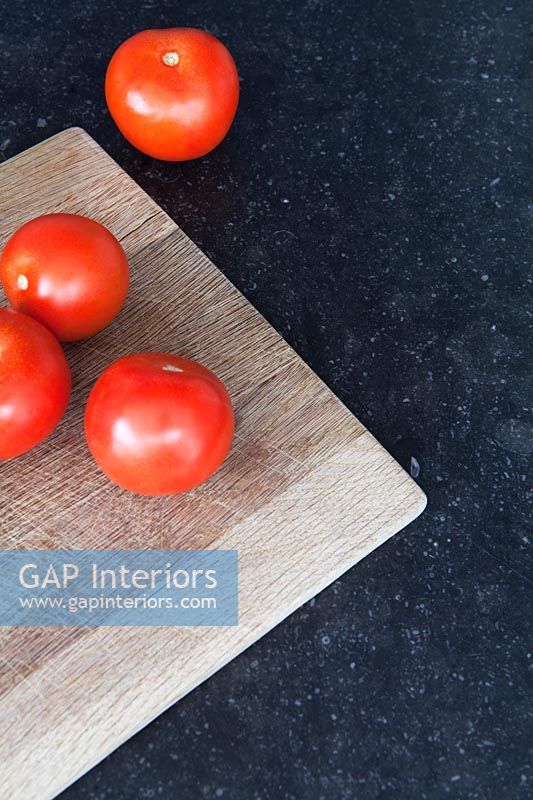 Tomatoes on kitchen surface 