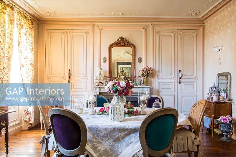 Classic dining room with floral curtains and period details 