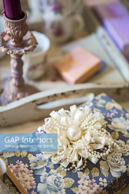 Floral paper covering book with decorative pearl rosette 