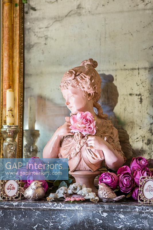 Classic bust - sculpture in pink covered with roses 