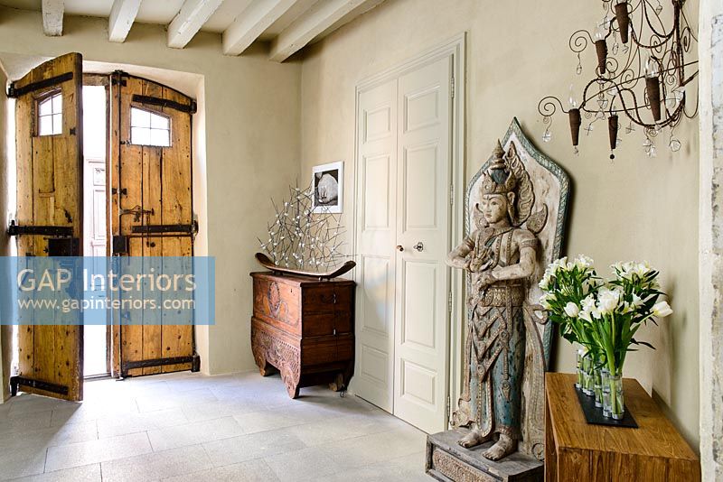Large wooden carved sculpture in classic hallway 