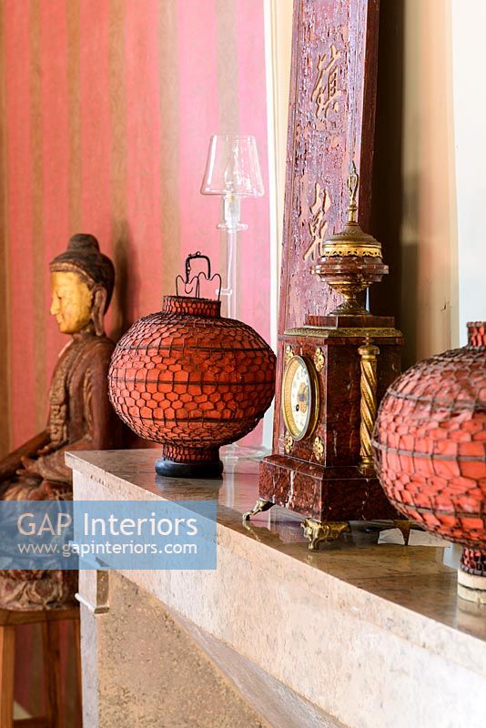 Chinese lanterns on mantelpiece with ornate clock 
