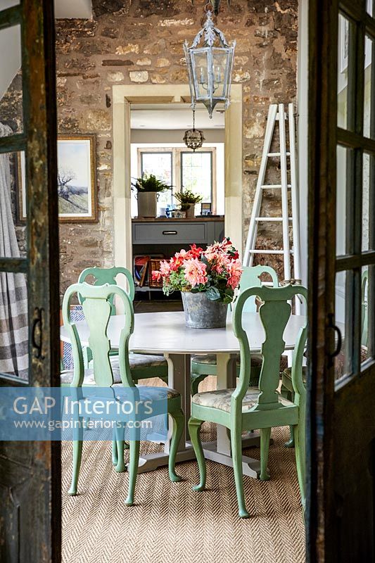 View through double doors to modern country dining room 