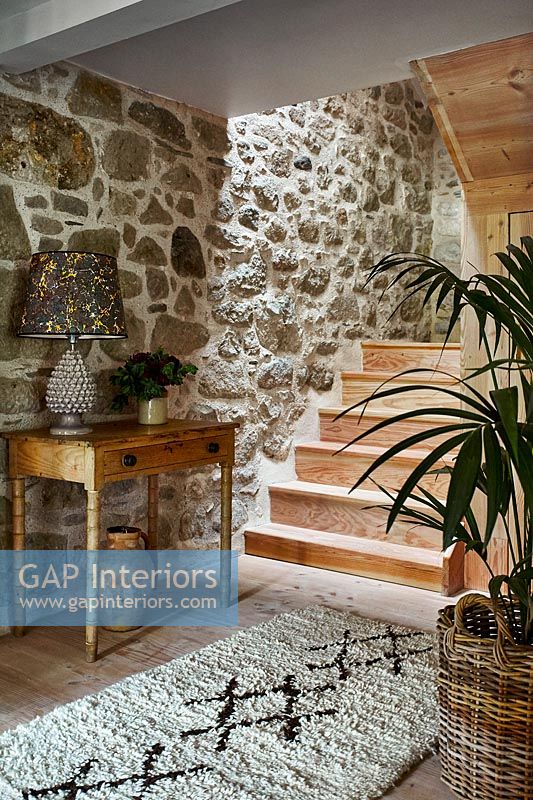 Exposed stone wall in modern country hallway