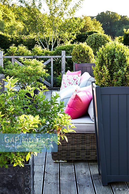 Wooden terrace with garden furniture detail 