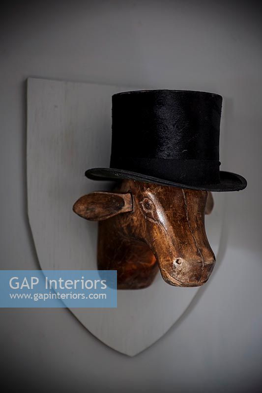 Close up wooden sculpture with top hat 