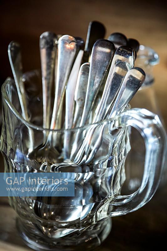 Close up jug of silver cutlery 