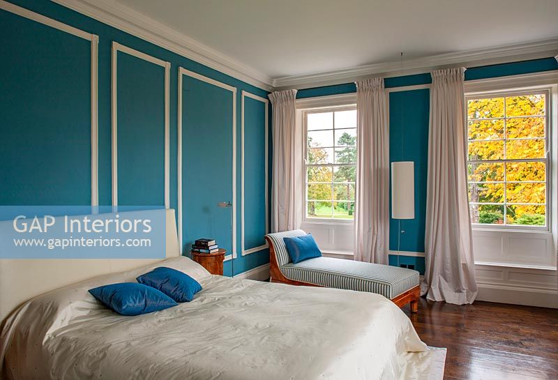 Master bedroom with blue painted paneled wall