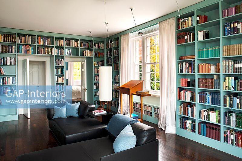 Wall to wall painted bookcases in classic library 