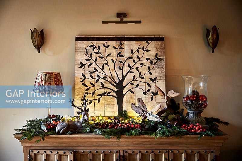 Christmas decorations on wooden sideboard 