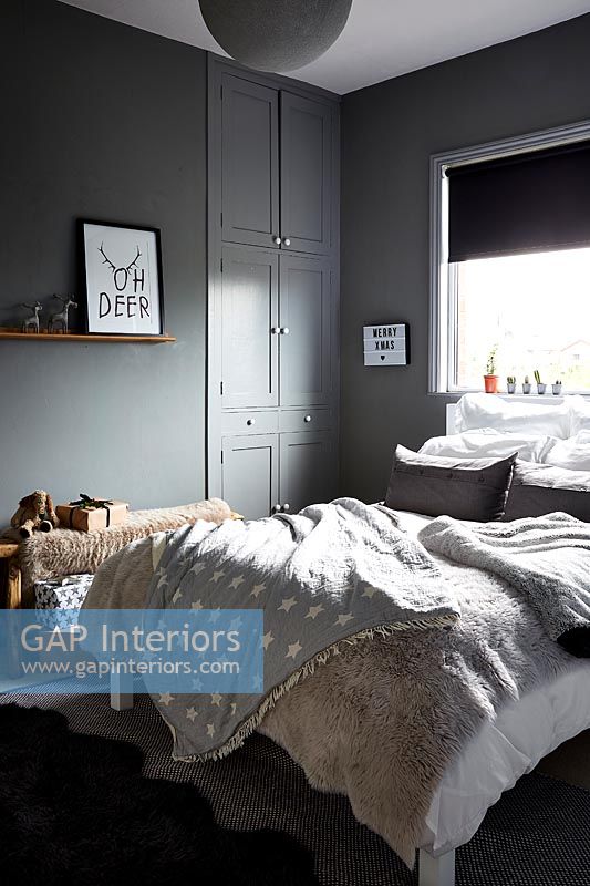 Dark grey painted walls in modern bedroom 