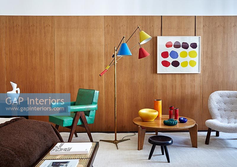 Wooden walls and colourful accessories in retro bedroom  