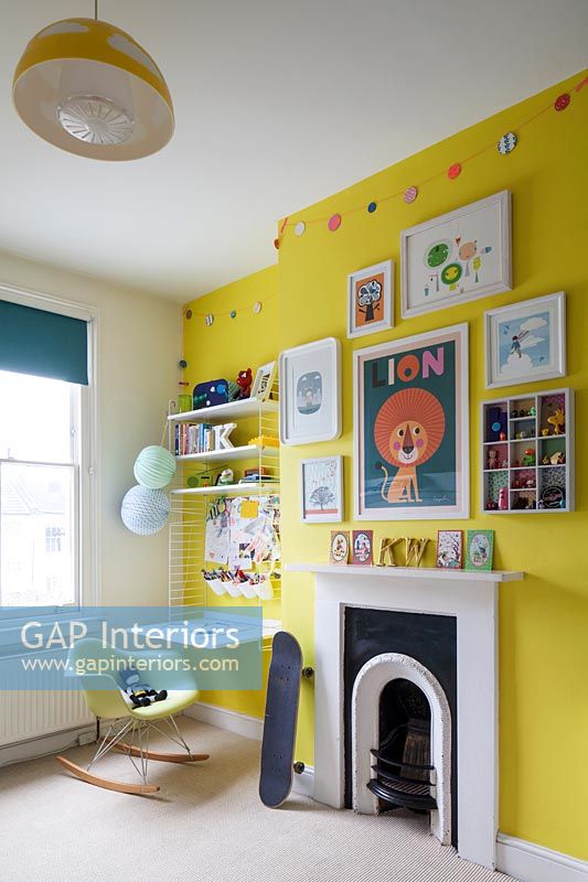 Childrens room with bright yellow feature wall 