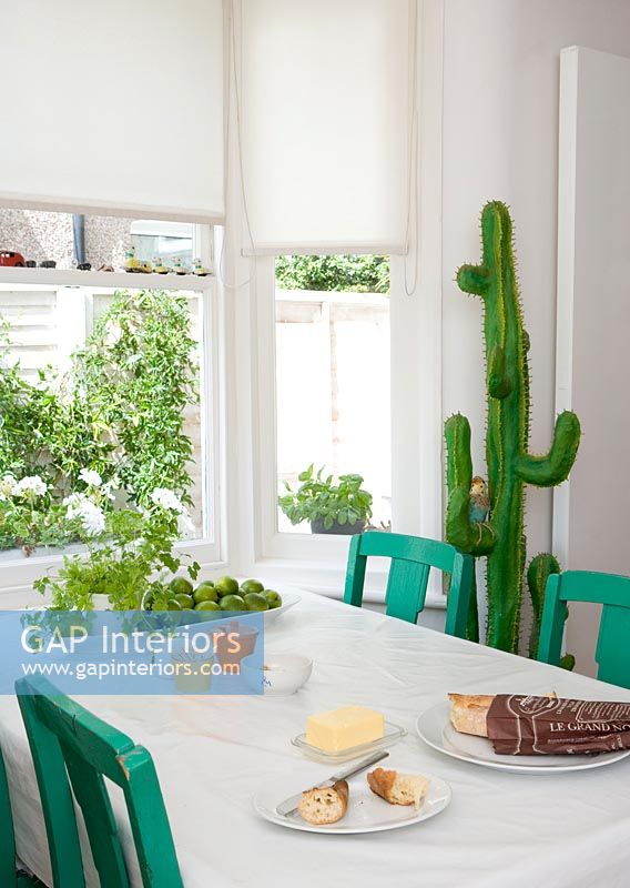 Toy cactus next to green and white dining table 