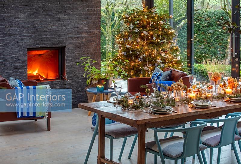 Modern dining room with fireplace decorated for Christmas 