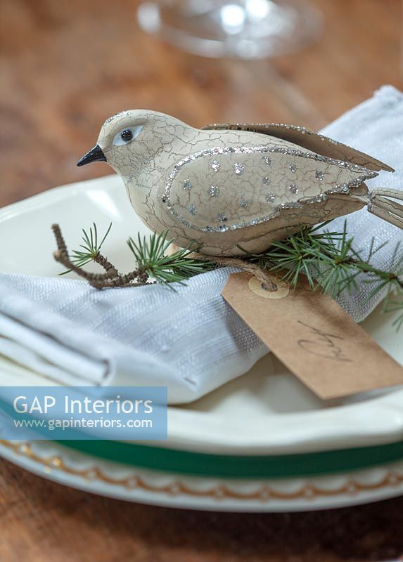 Dove decoration on dining table place setting at Christmas 