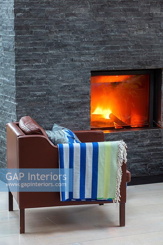 Slate wall fireplace and leather armchair 