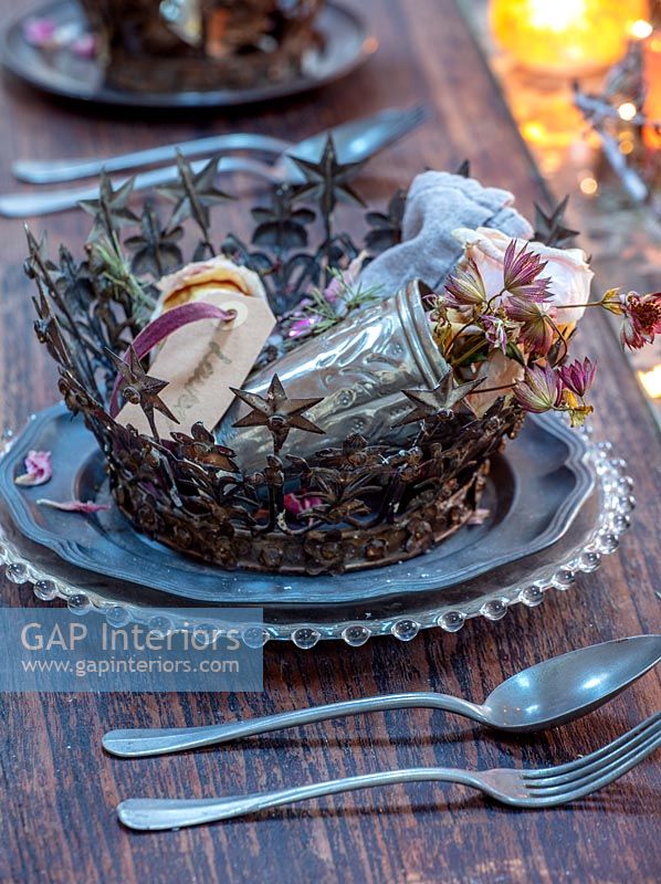 Decorative metal crown on place setting for Christmas dinner 