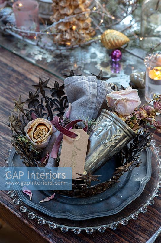 Metal crown and decorations on Christmas table setting 