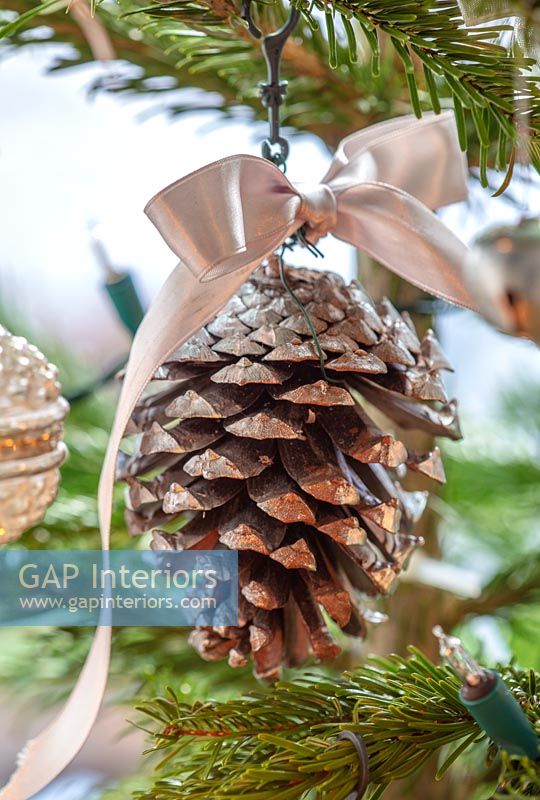 Pine cone and ribbon on Christmas tree 