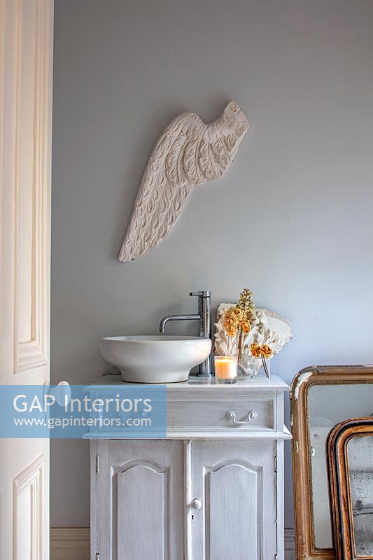 Decorative plaster angel wing on bathroom wall 