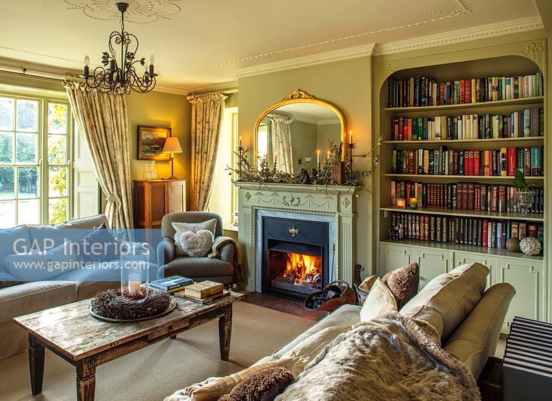 Cosy classic living room with lit fire