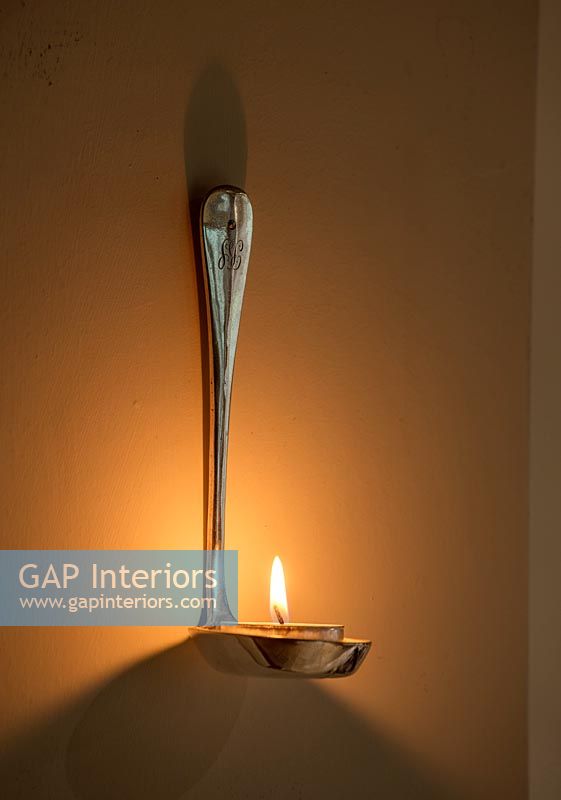 Vintage silver spoon fashioned into a wall mounted candle holder. 