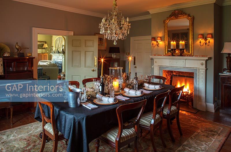Classic dining room with lit fire at Christmas 