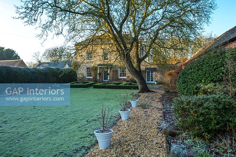 Traditional country house and back garden in winter 