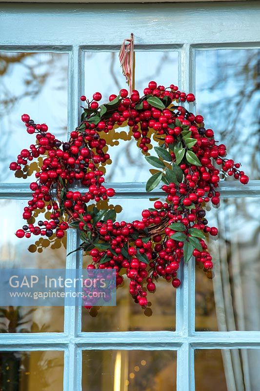 Red berry wreath on window 