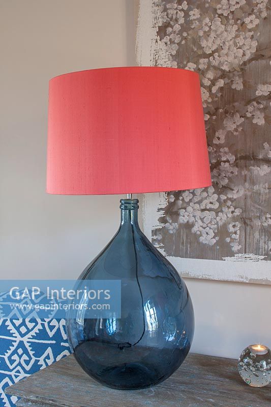 Blue glass lamp with bright apricot pink lampshade 